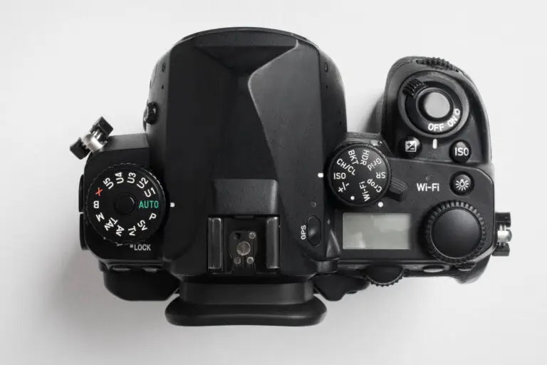 Best Canon camera for vlogging in 2025 – creator using Canon EOS R50 with tripod and mic setup outdoors.